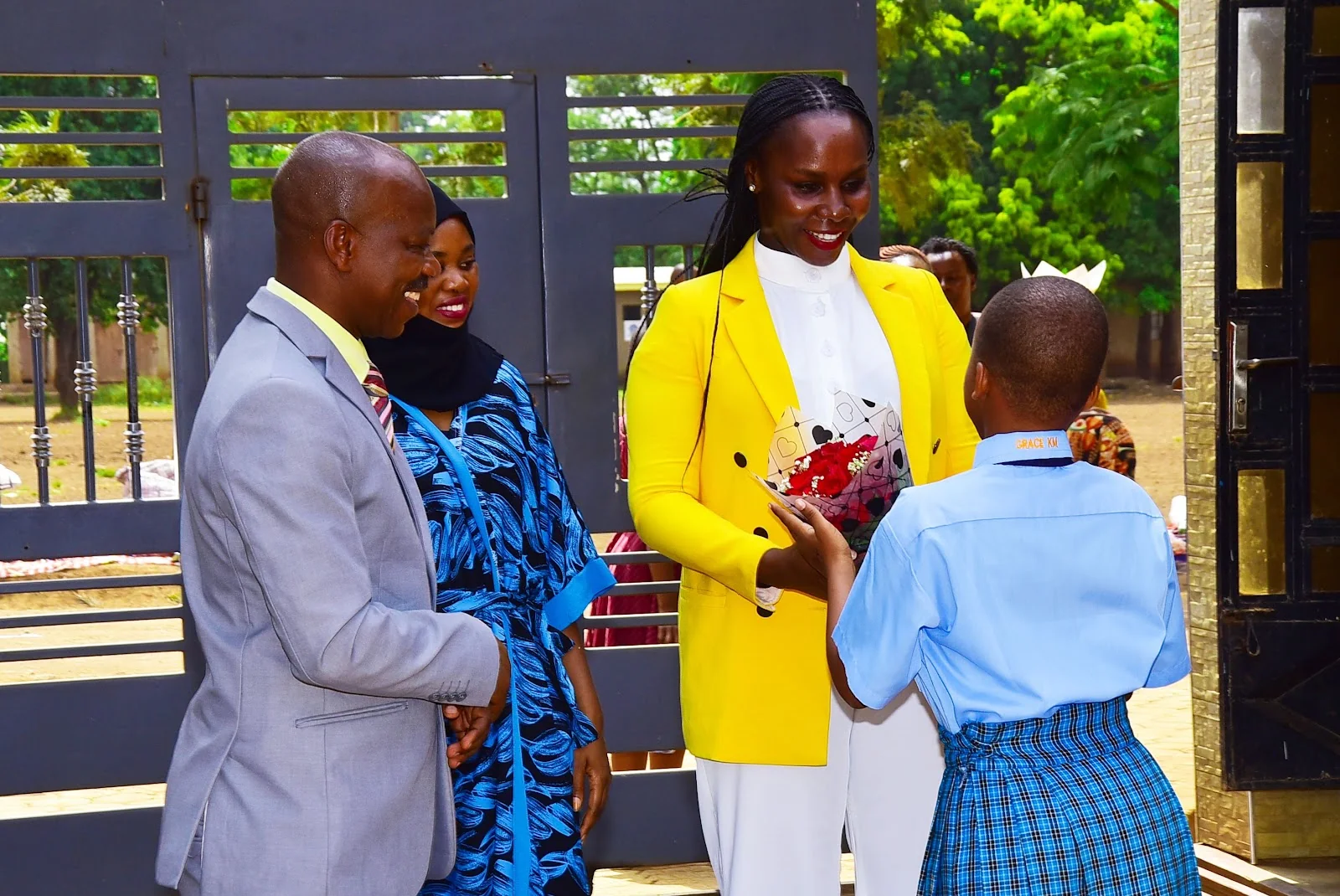 Student welcoming a guest at the 2025 graduation celebration